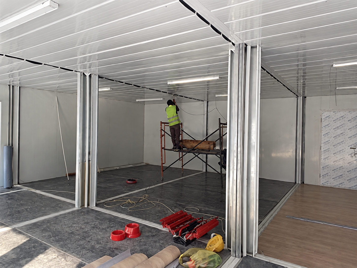 Interior of the Riyadh modular container office during fit-out, showing connected room space