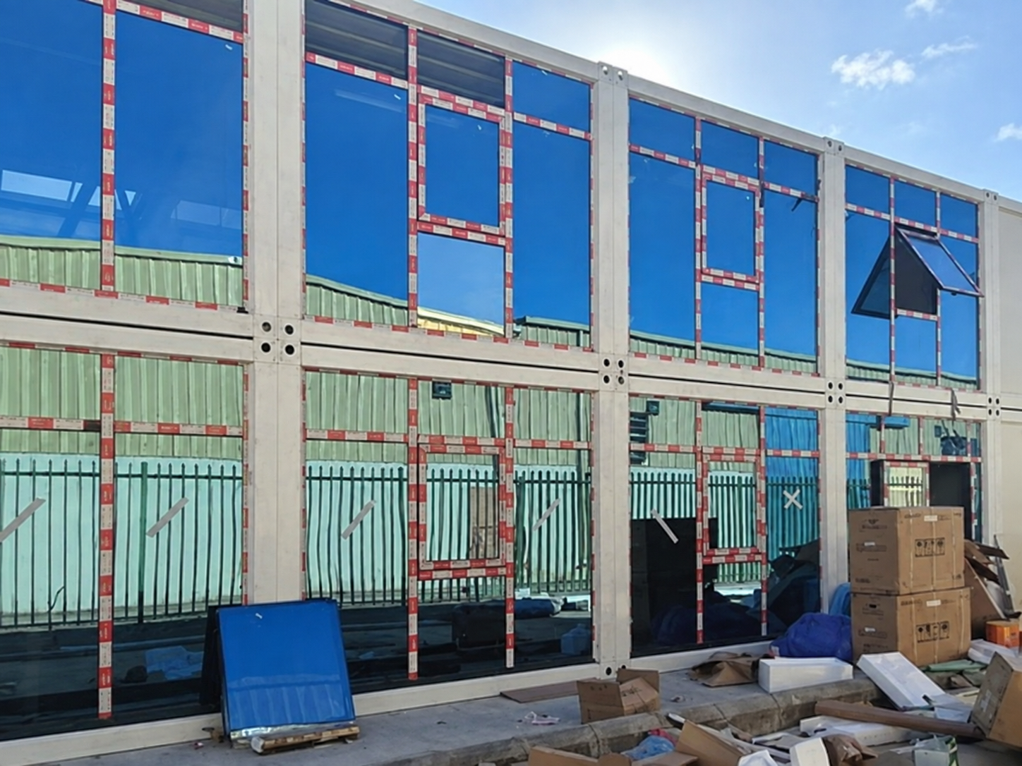 Glazed facade detail of the two-storey Riyadh modular office during assembly