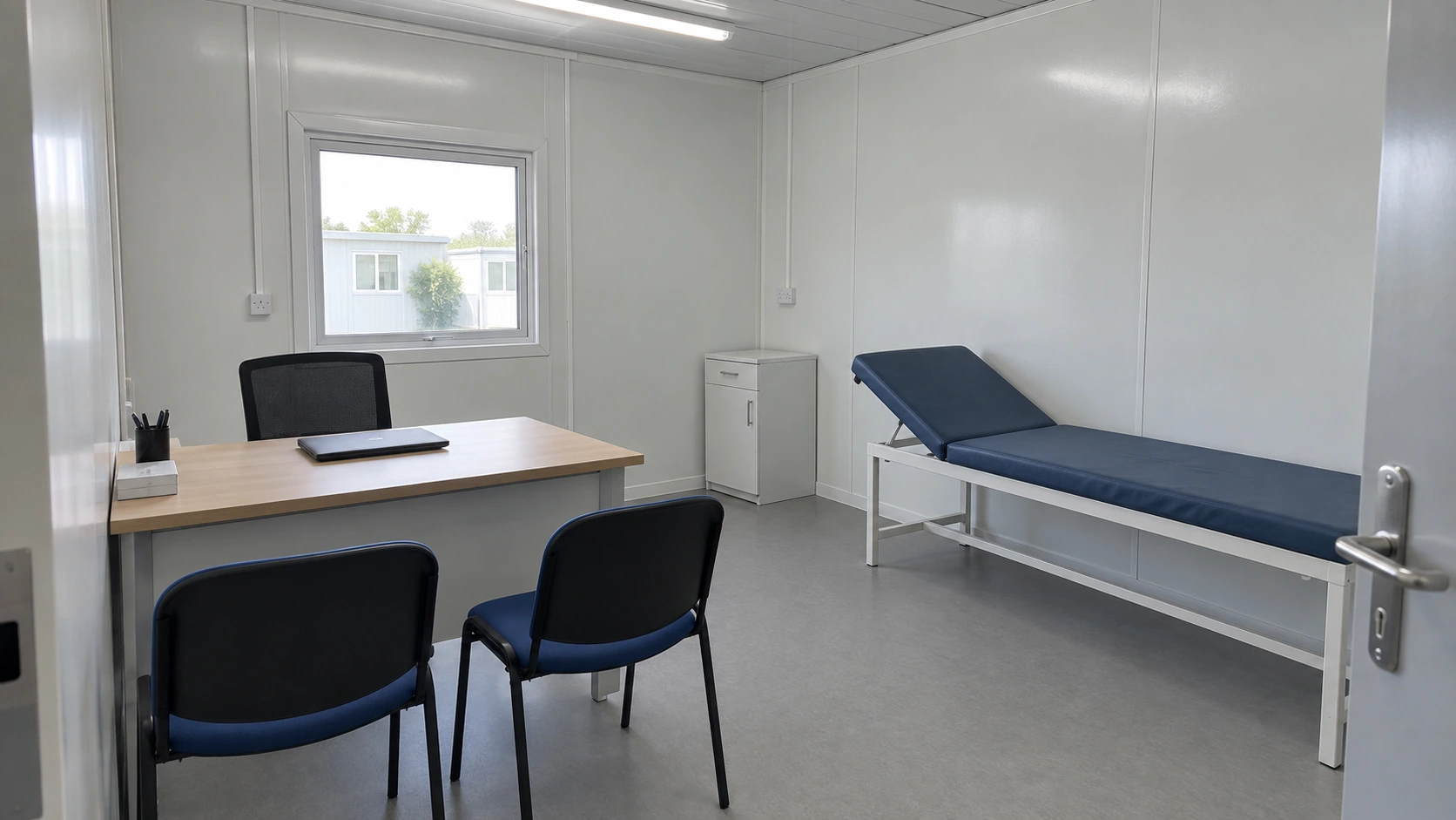 Plain consultation room with a desk, two visitor chairs and examination couch