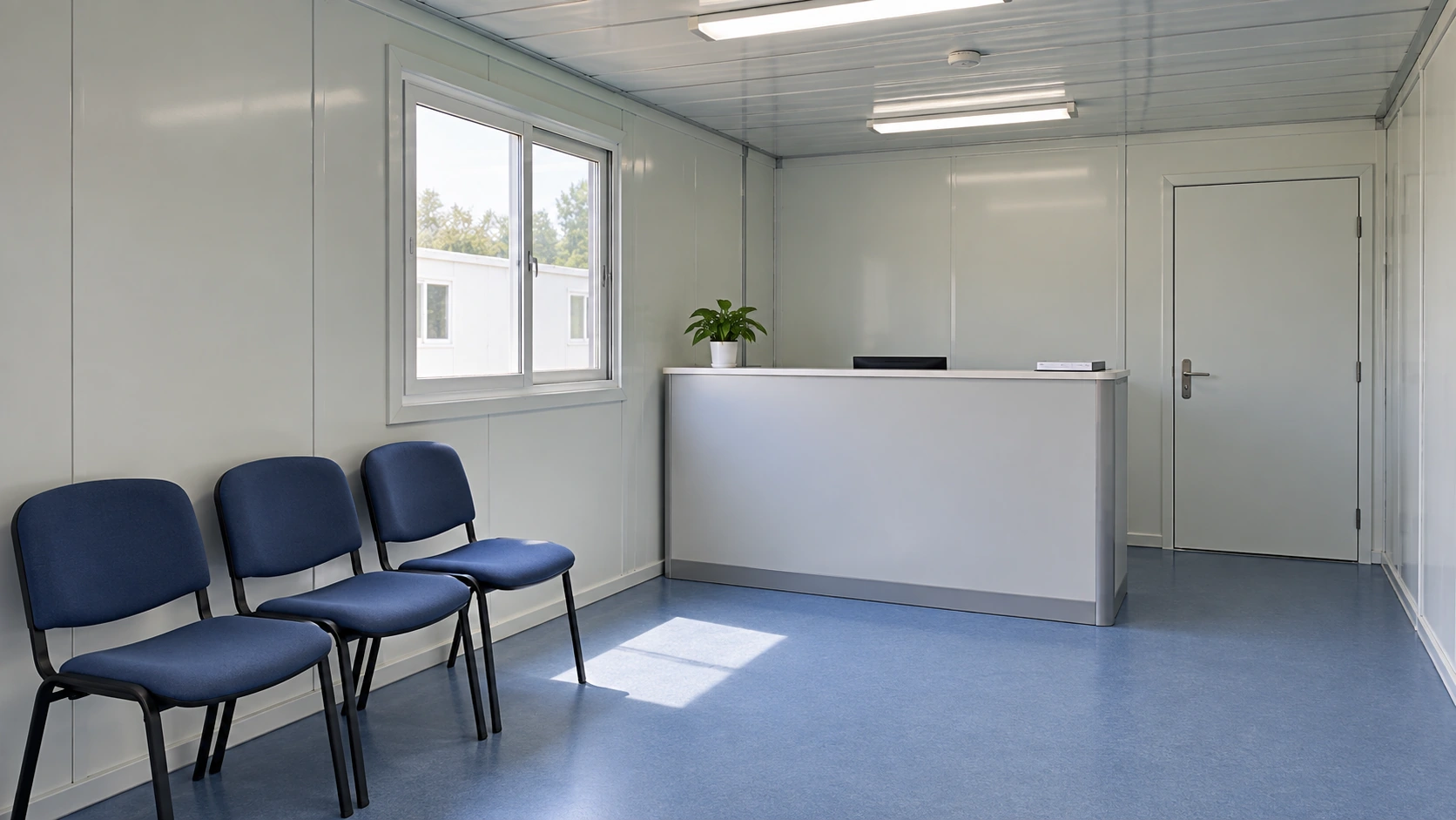 Modular clinic reception with a small desk and three waiting chairs