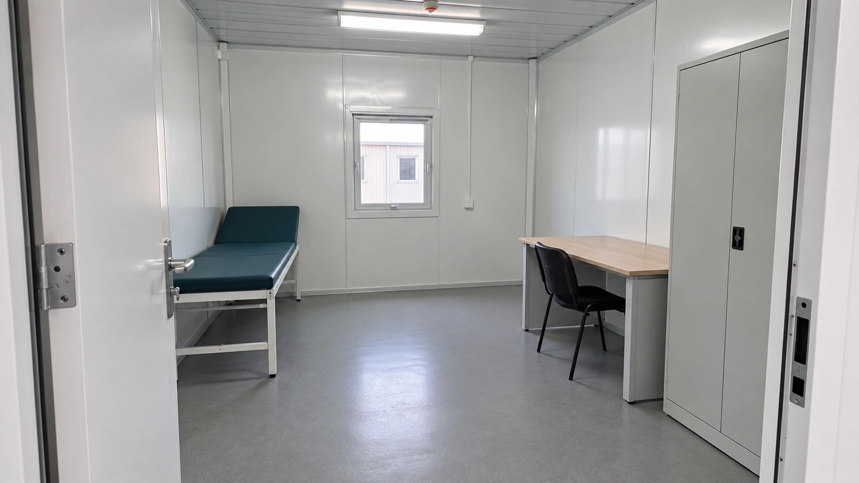 Unoccupied modular consultation room showing a clear entrance and furniture placement