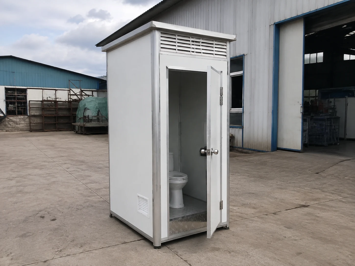 Illustrative compact prefabricated toilet cabin with an open door