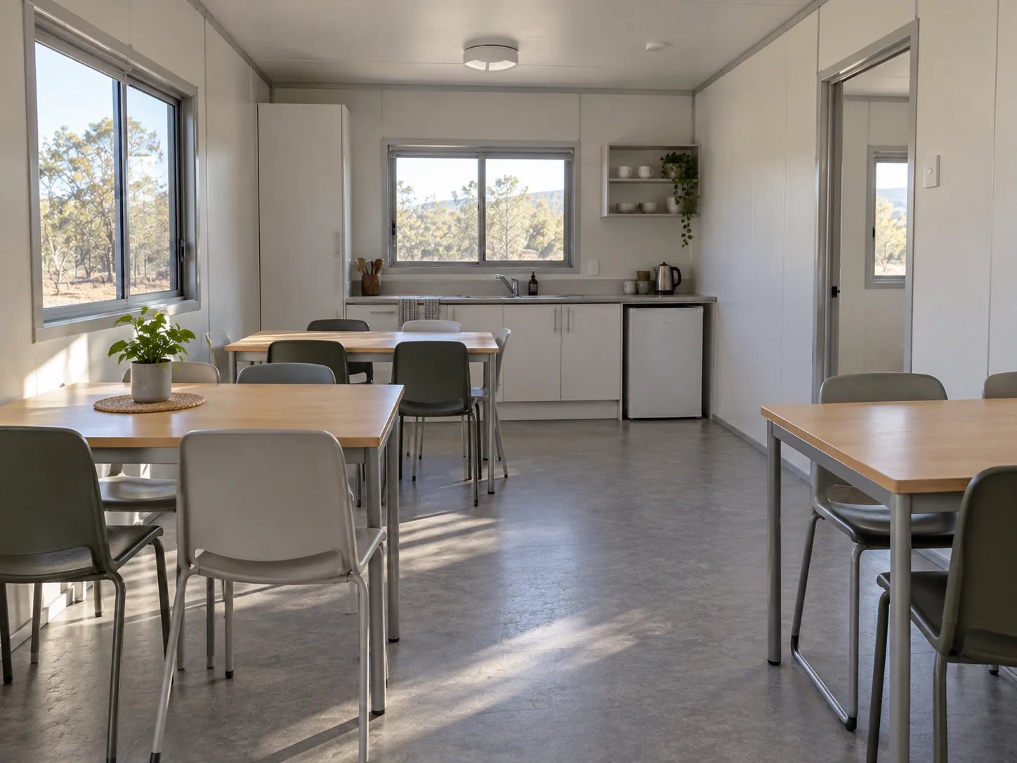 Concept illustration: Shared dining space with tables and a practical kitchen area