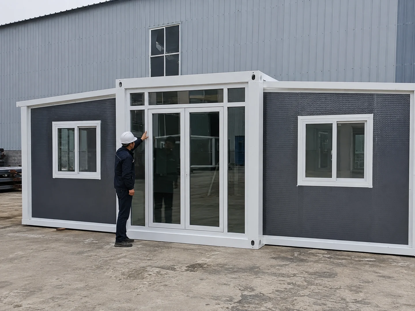 Worker checking the entrance and frame joint of a double-wing expandable house
