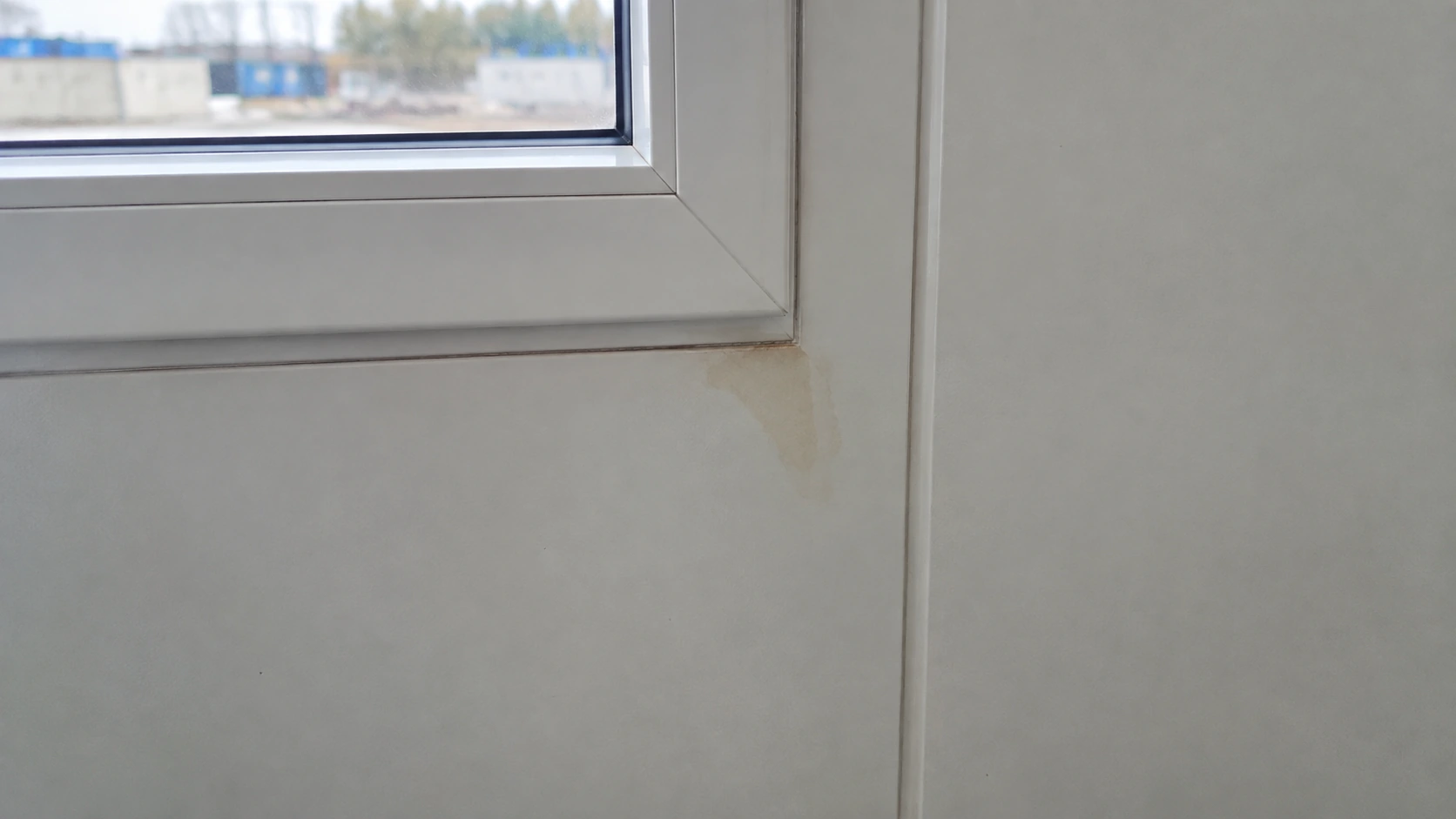 New concept illustration of a small water discoloration below an interior modular window sill.