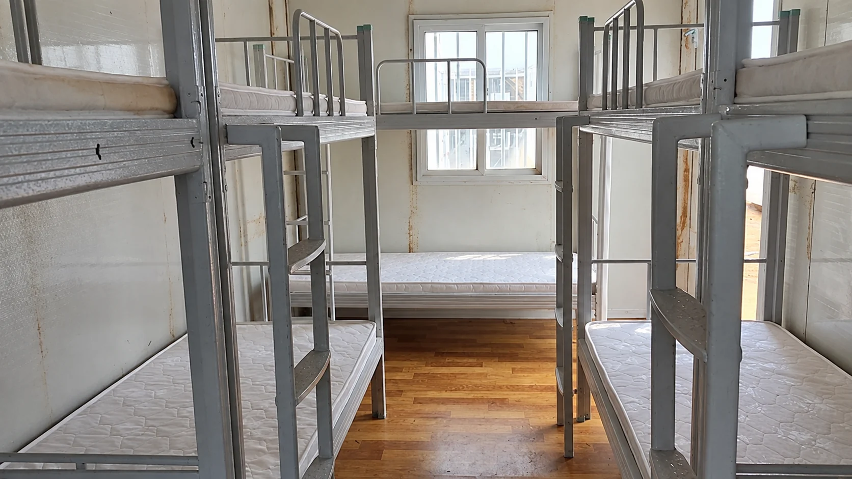 Metal bunk beds arranged inside a modular accommodation room