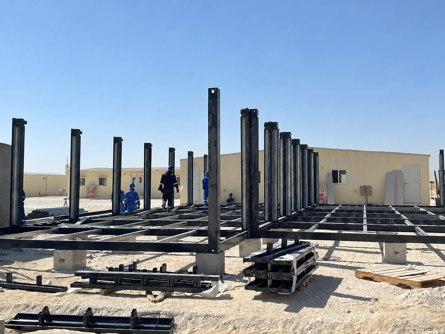 Upright steel posts being fixed to floor framing at the project site