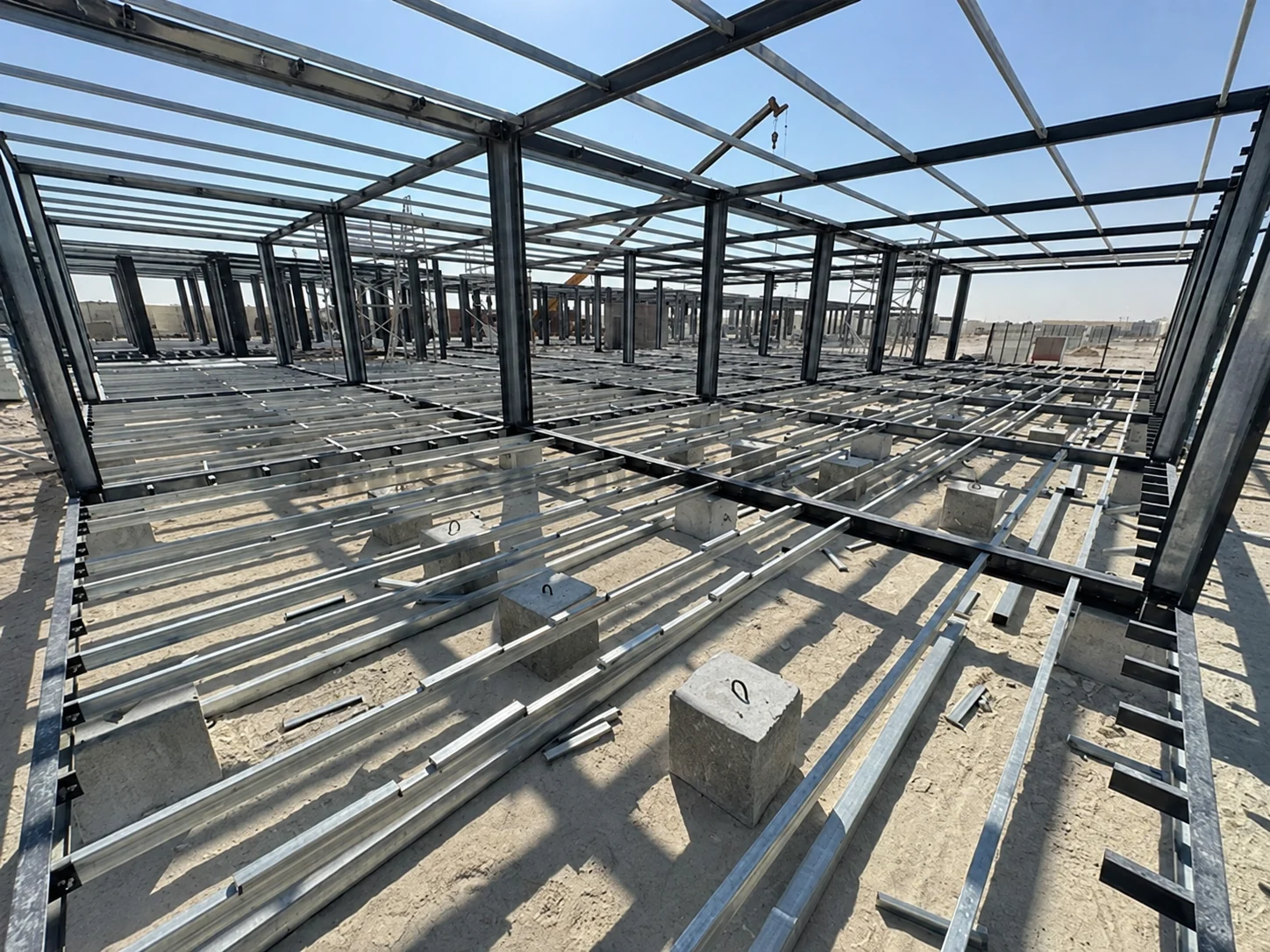 Steel roof and floor framing inside a large modular building under construction