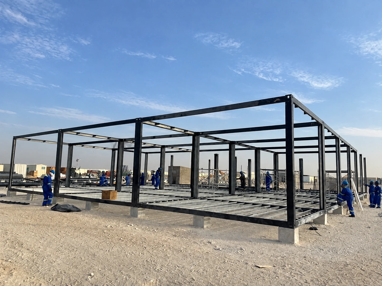 Wide steel frame of a modular building on supports during assembly