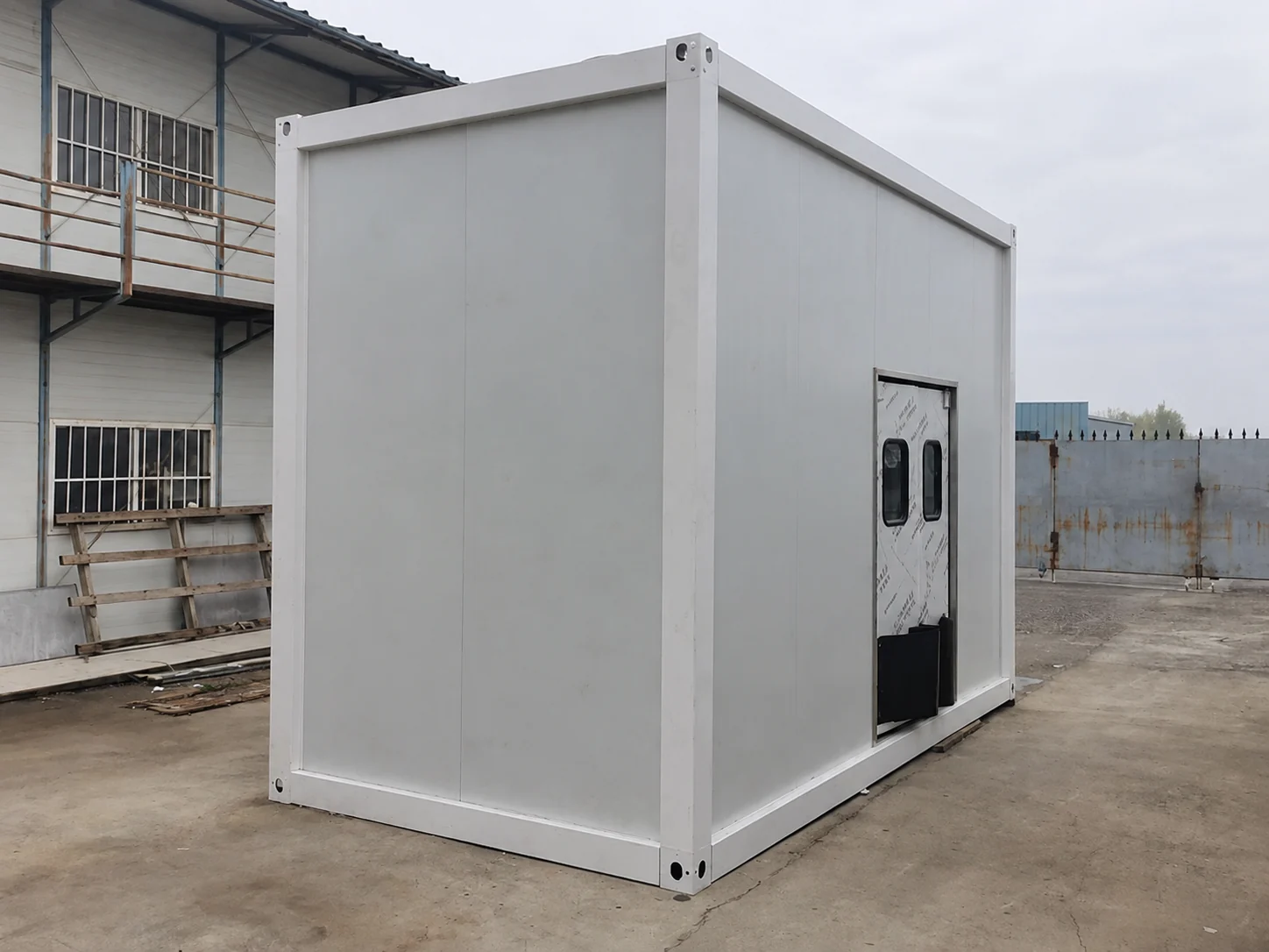 Opposite exterior view of the white service module with a door