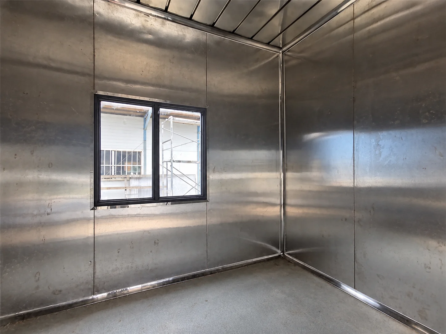 Stainless-lined wall and window inside the service module