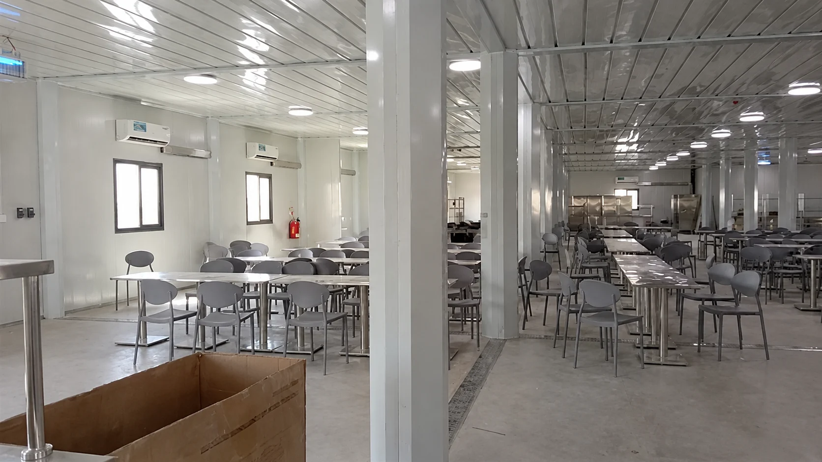 Rows of chairs and tables inside the modular dining hall