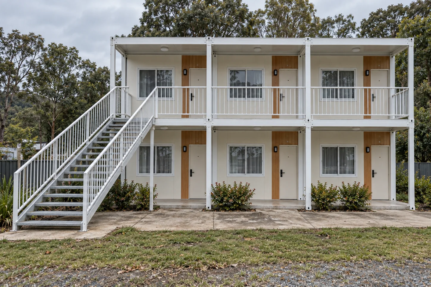 Two-storey modular guestroom block with an open stair landing connecting to the upper corridor