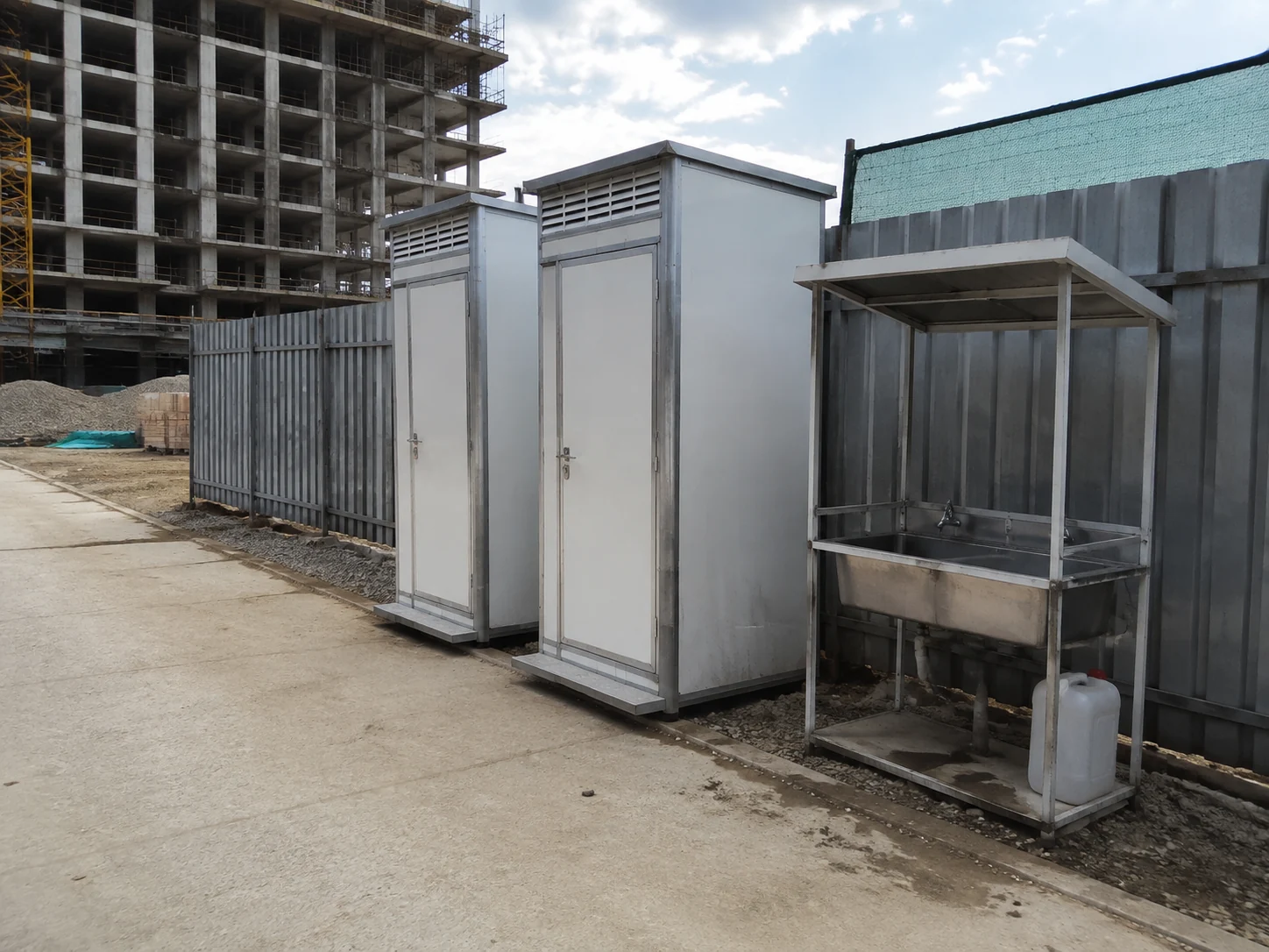 Illustrative toilet and handwashing facilities beside a construction work area