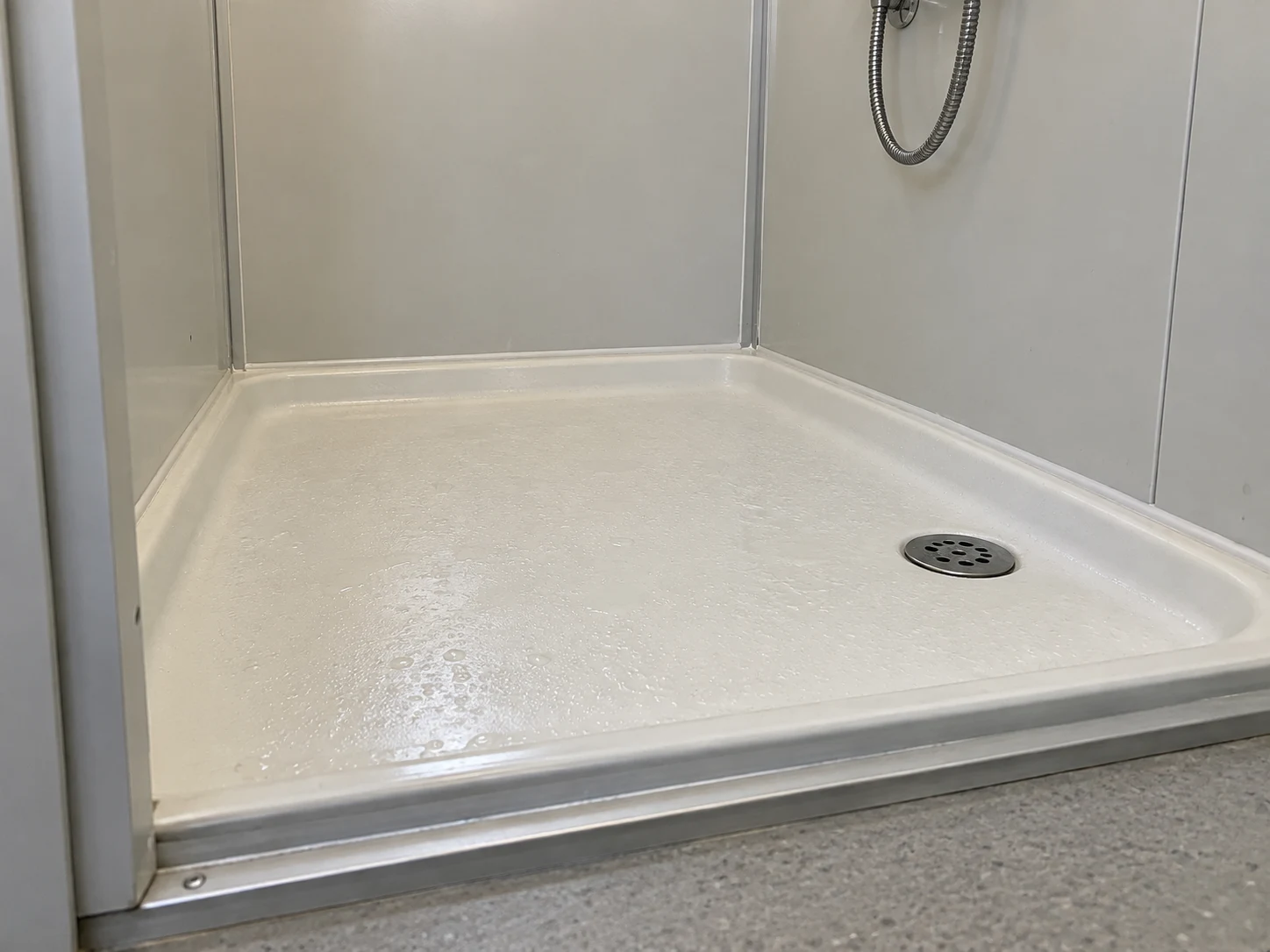 Illustrative shower tray, drain and wall junction detail