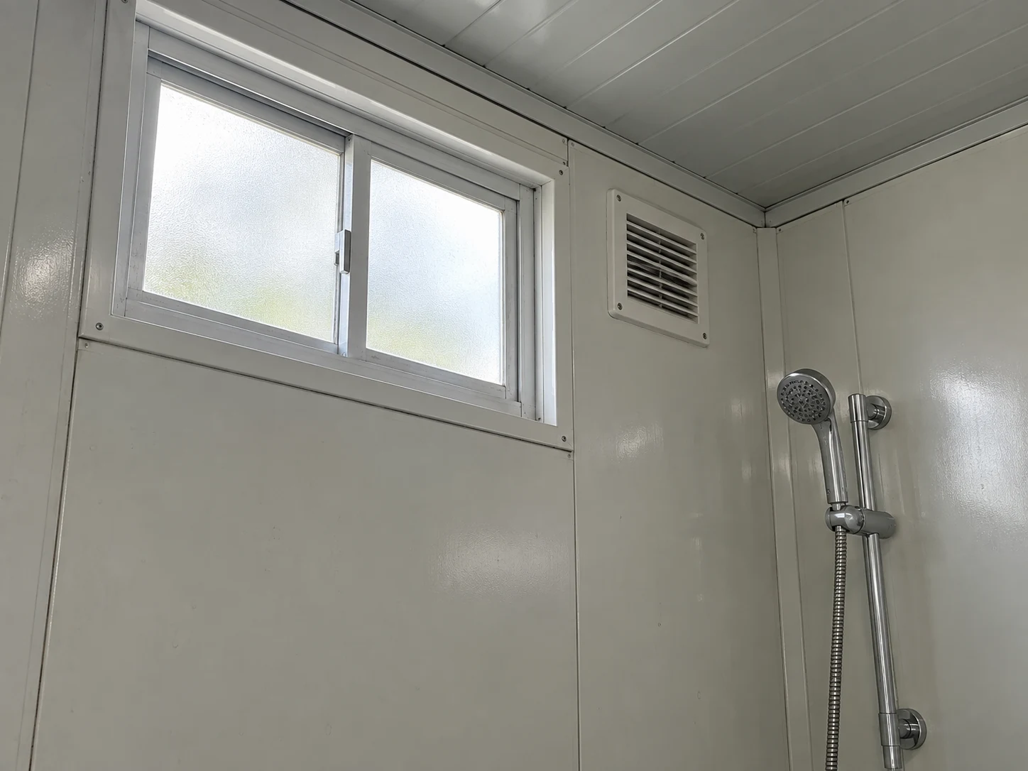 Illustrative shower privacy window and ventilation louver