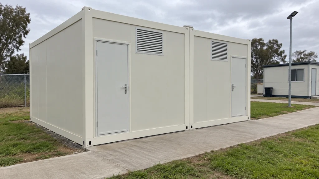 Concept of a modest modular shower block beside a camp pedestrian path