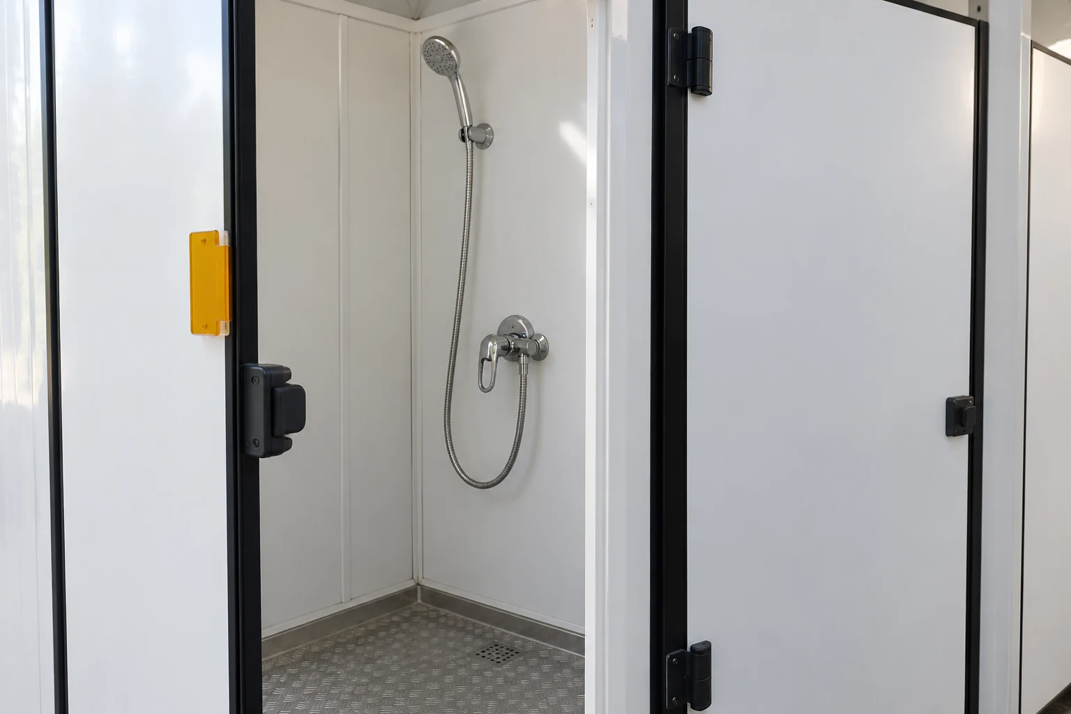 Illustrative scene: a quiet shower bay with a removable state marker beside an adjacent closed cubicle.
