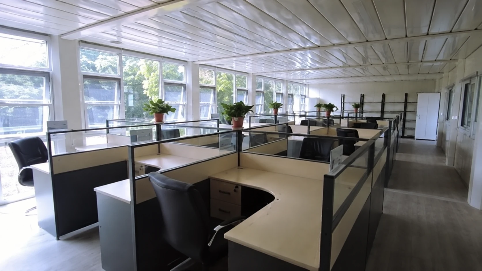 Reference interior showing open-plan office desks and low partitions