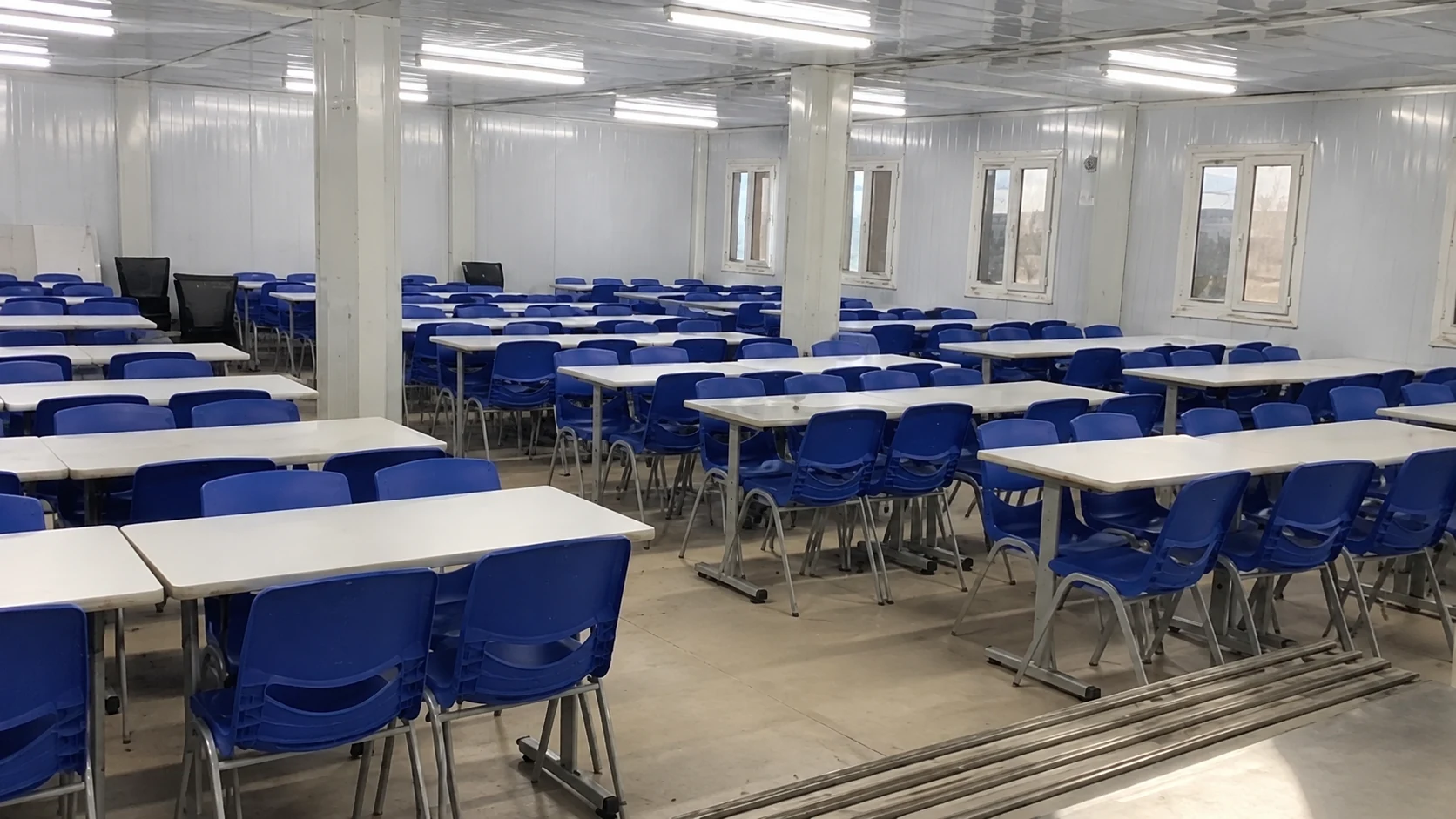 Reference classroom interior with blue chairs and shared desks