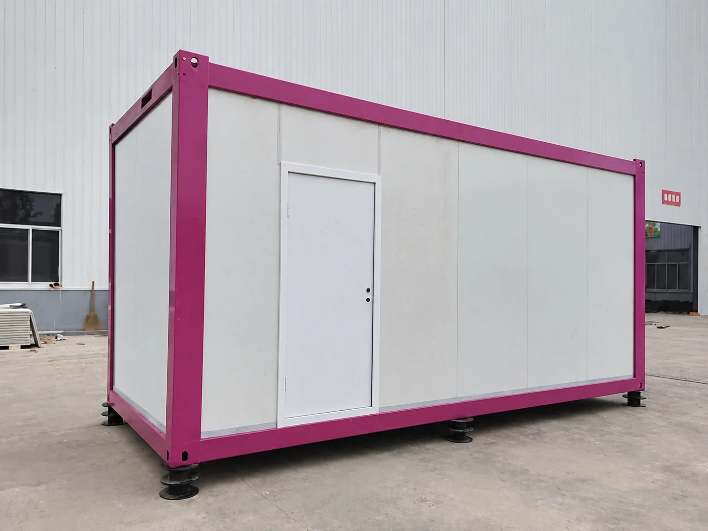 Reference white modular cabin with a pink frame and plain door