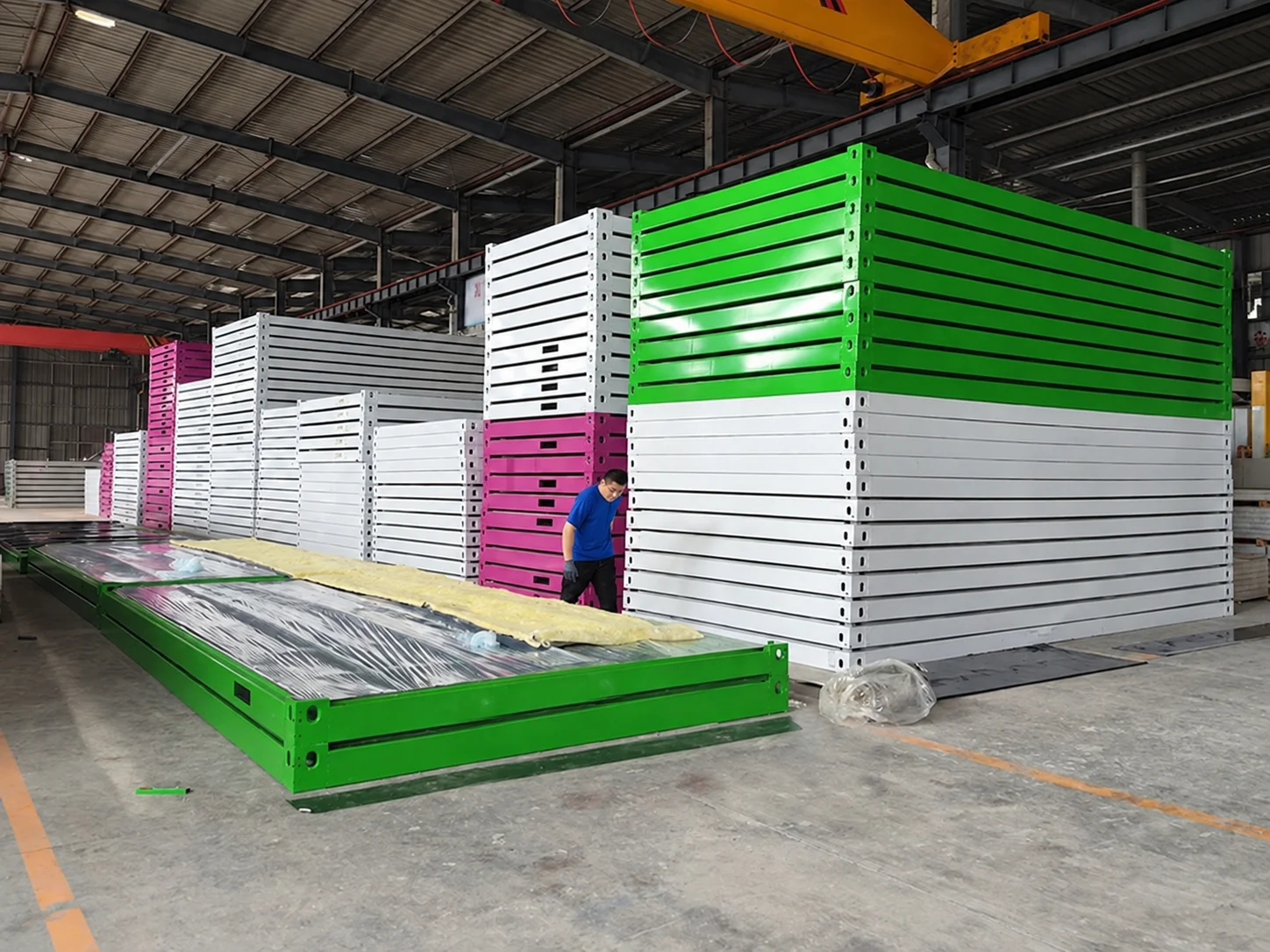 Workshop reference showing stacks of green and white module frames