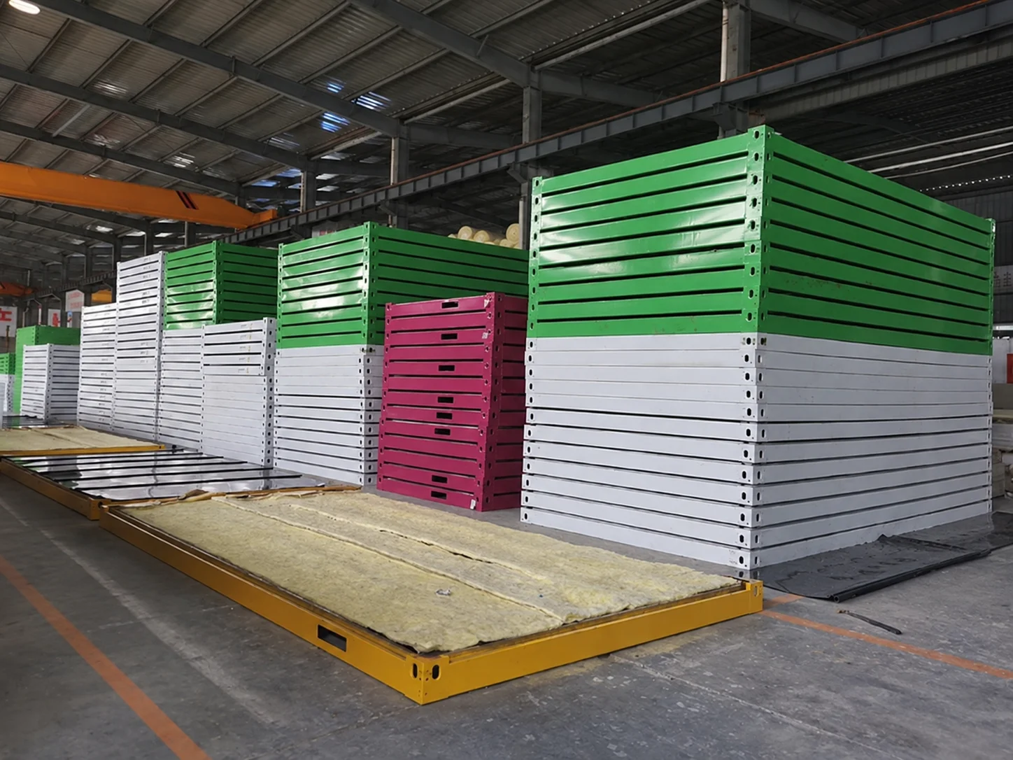 Workshop reference showing stacked frames beside a yellow floor assembly