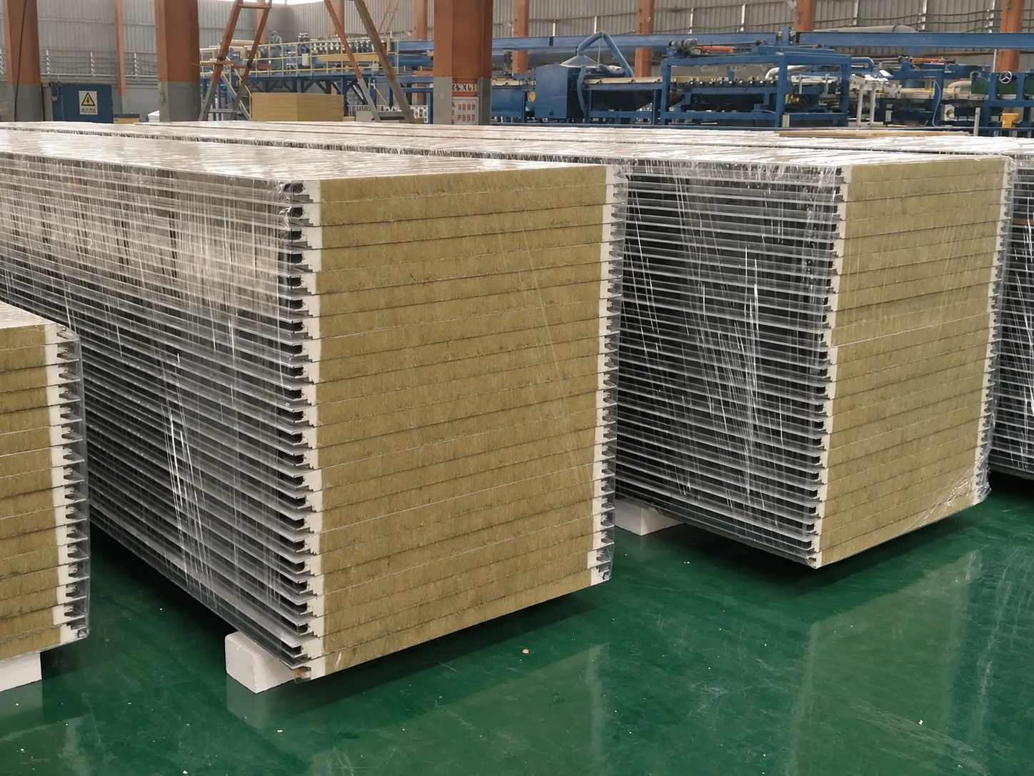 Workshop reference showing panel stacks on a green floor