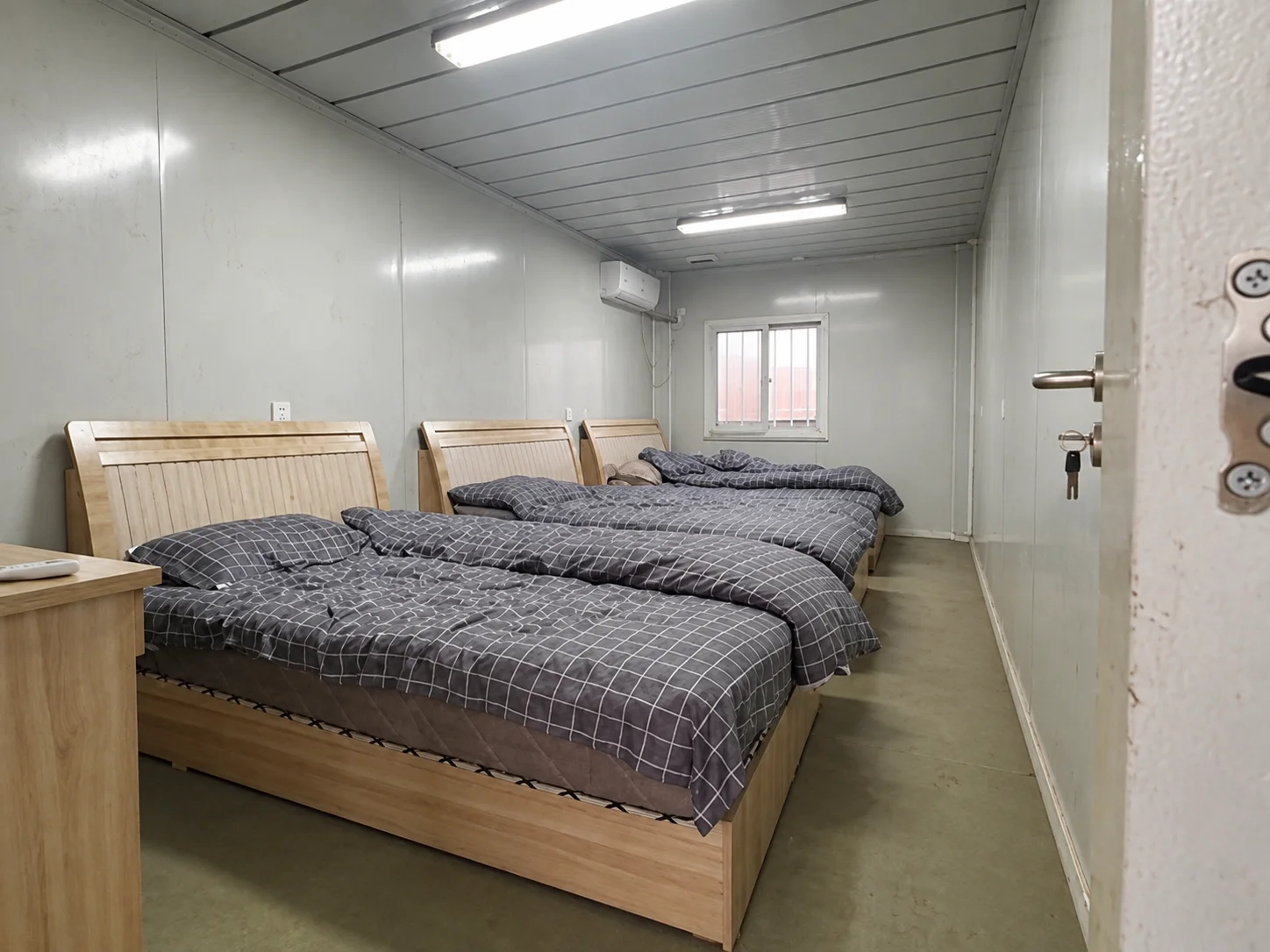 Reference bedroom interior with two beds and a narrow aisle