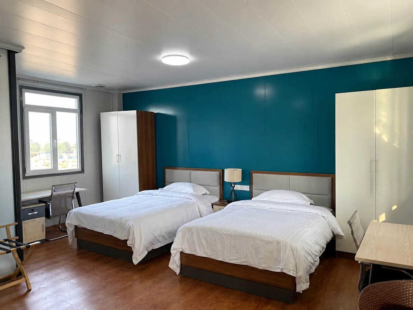 Reference bedroom with twin beds and a blue accent wall