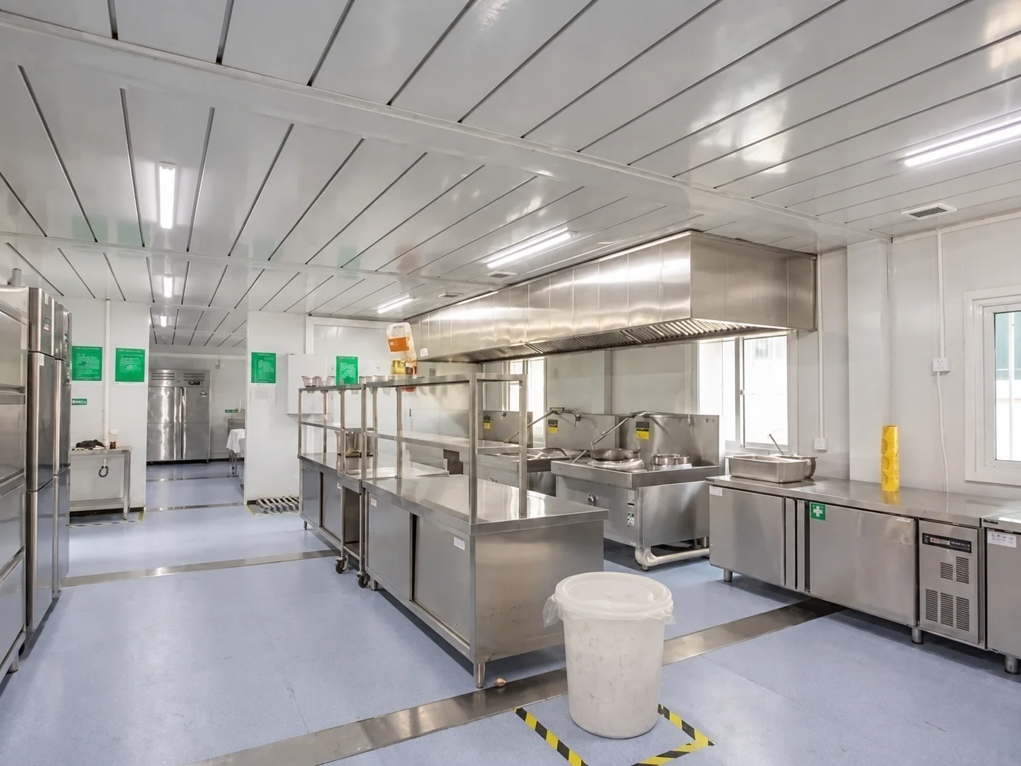 Reference commercial kitchen interior with metal work surfaces