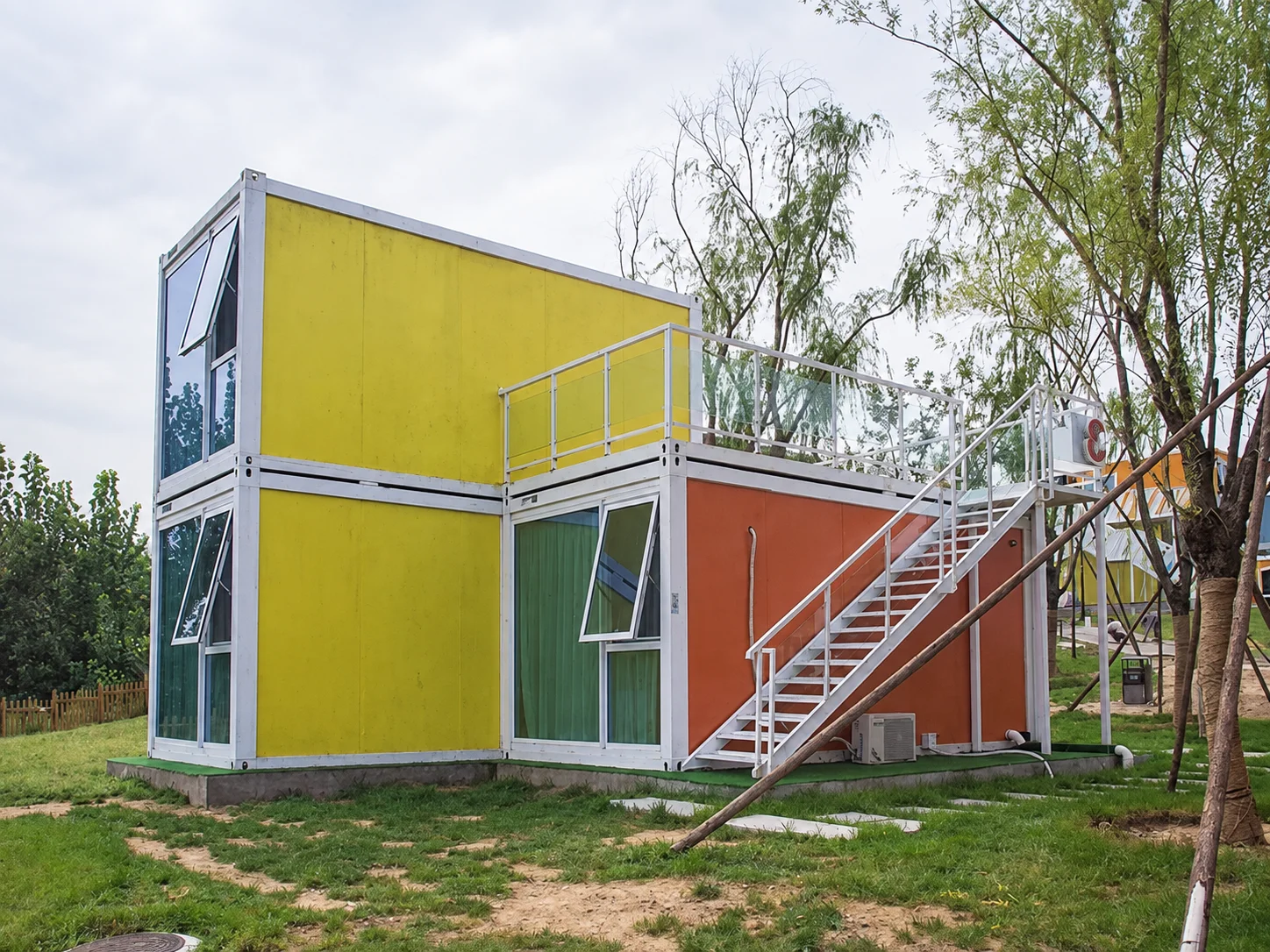 Reference yellow-and-orange modular rooms with exterior stairs