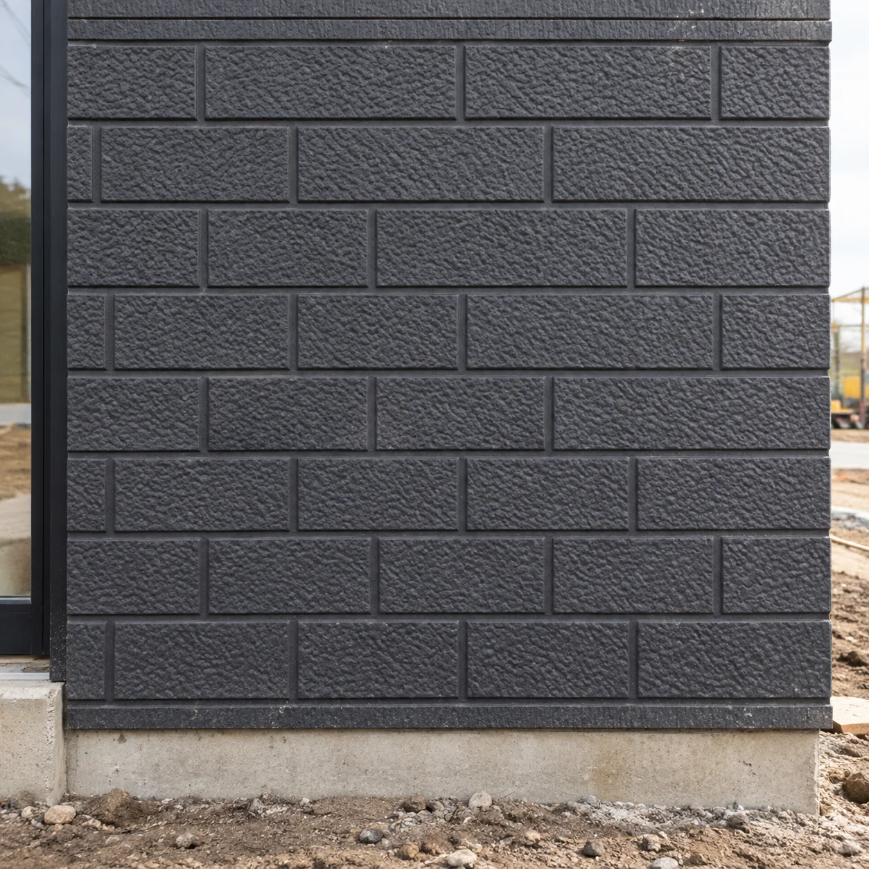 Reference dark grey brick-pattern exterior panel
