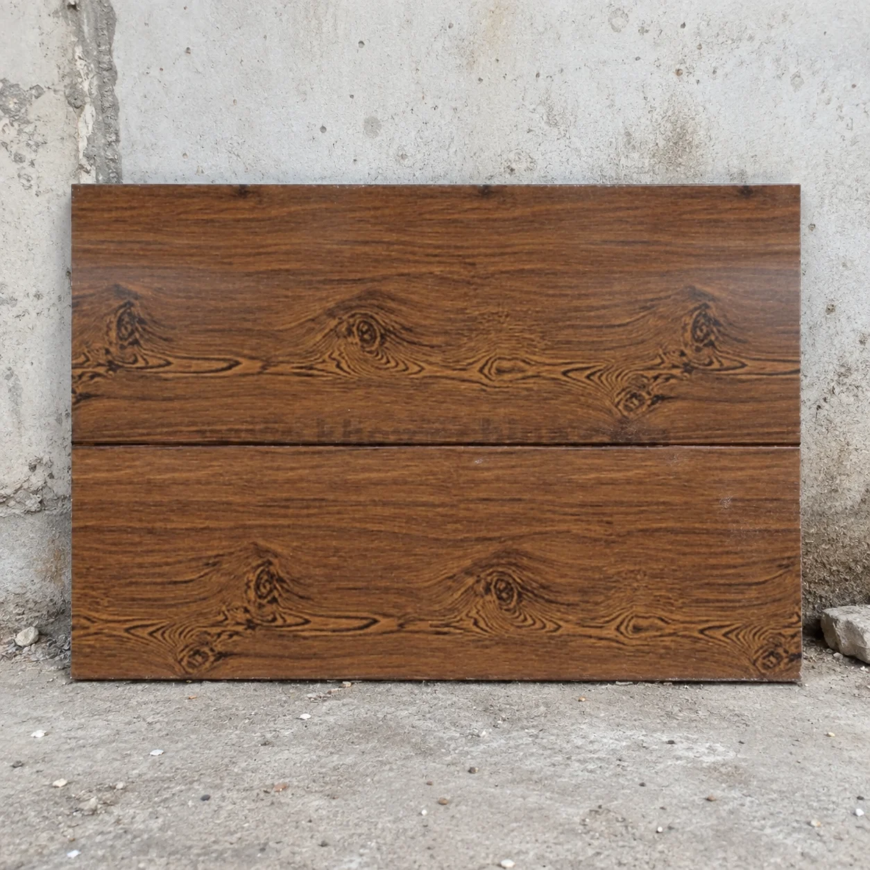 Reference brown wood-pattern panel sample leaning against a wall