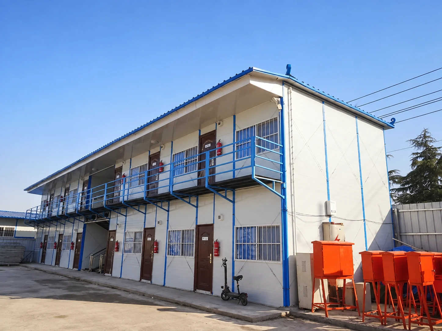 Reference two-storey building with a blue exterior walkway