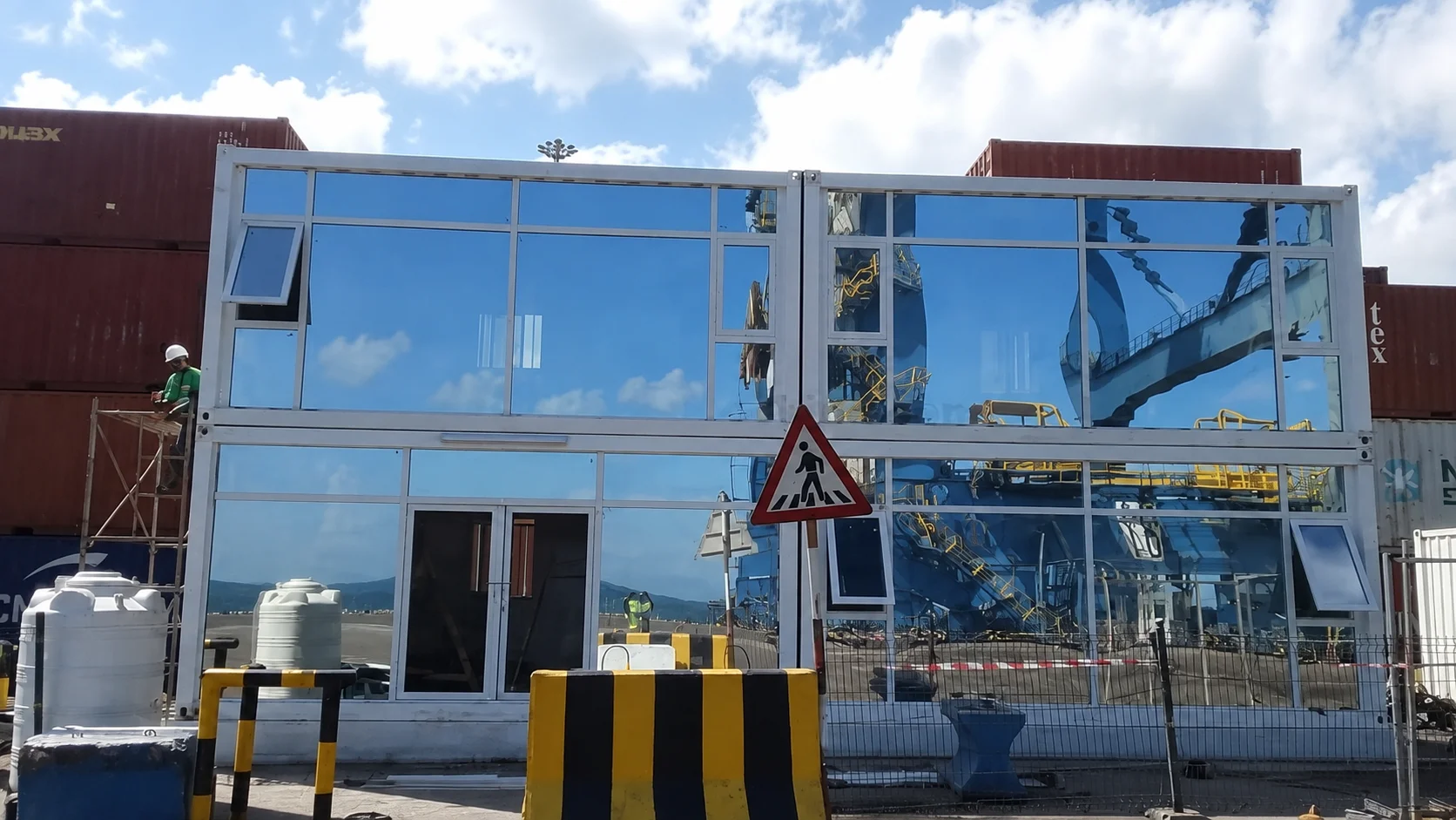 Reference glazed two-storey modular building beside a road