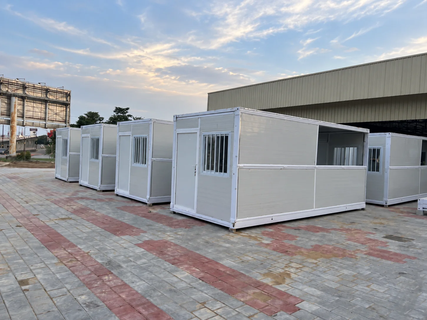 Reference row of small white modular rooms with open doors