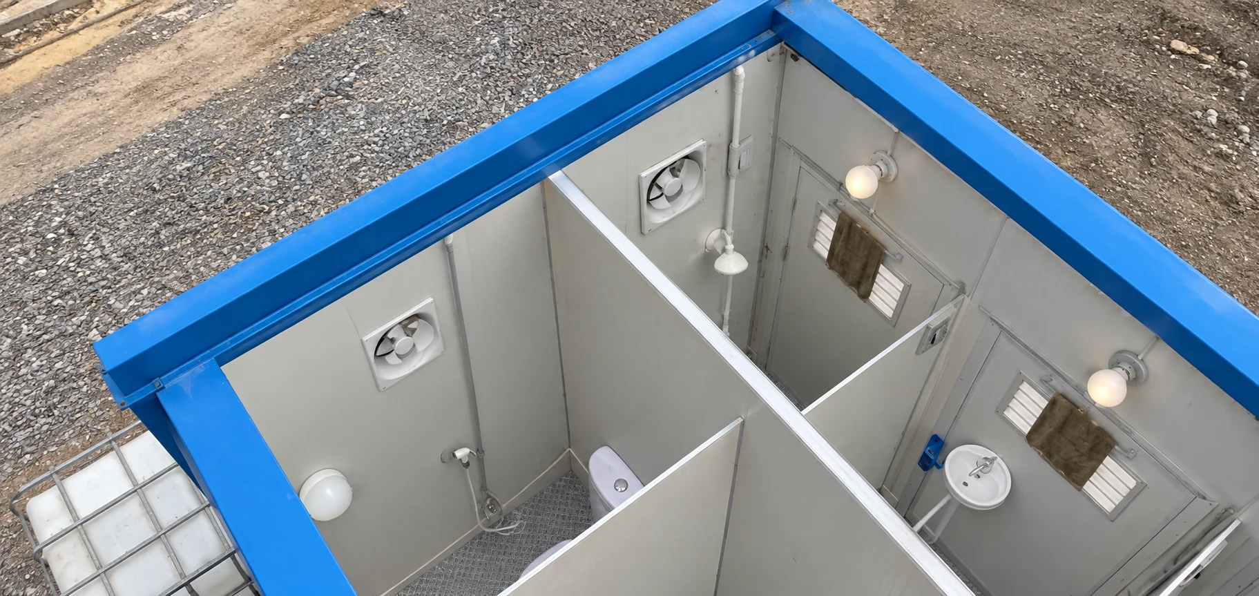 Oblique cutaway reference of sanitation cubicles, wall vents, lights and washbasins.