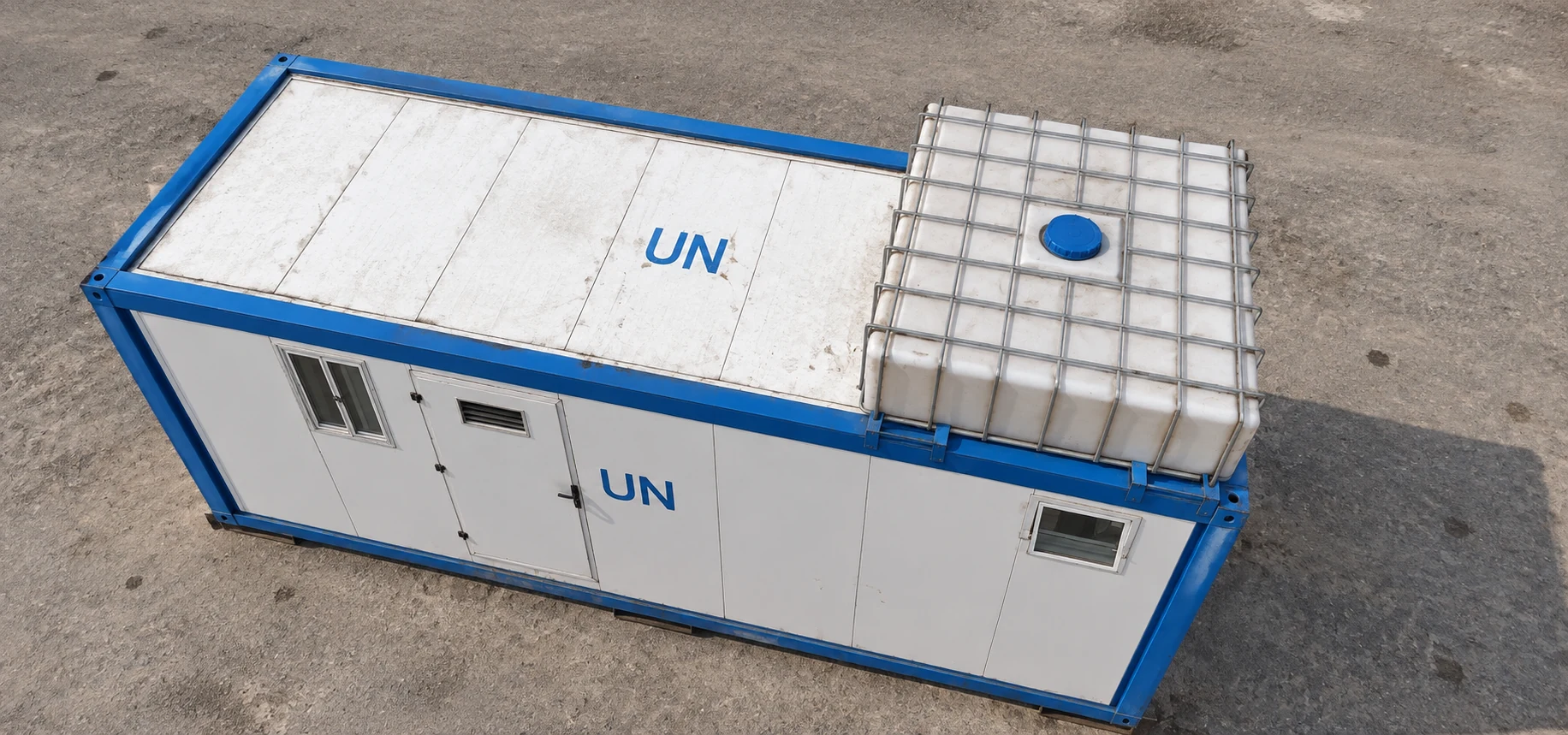Overhead reference view of a white sanitation module roof, blue frame and caged tank.